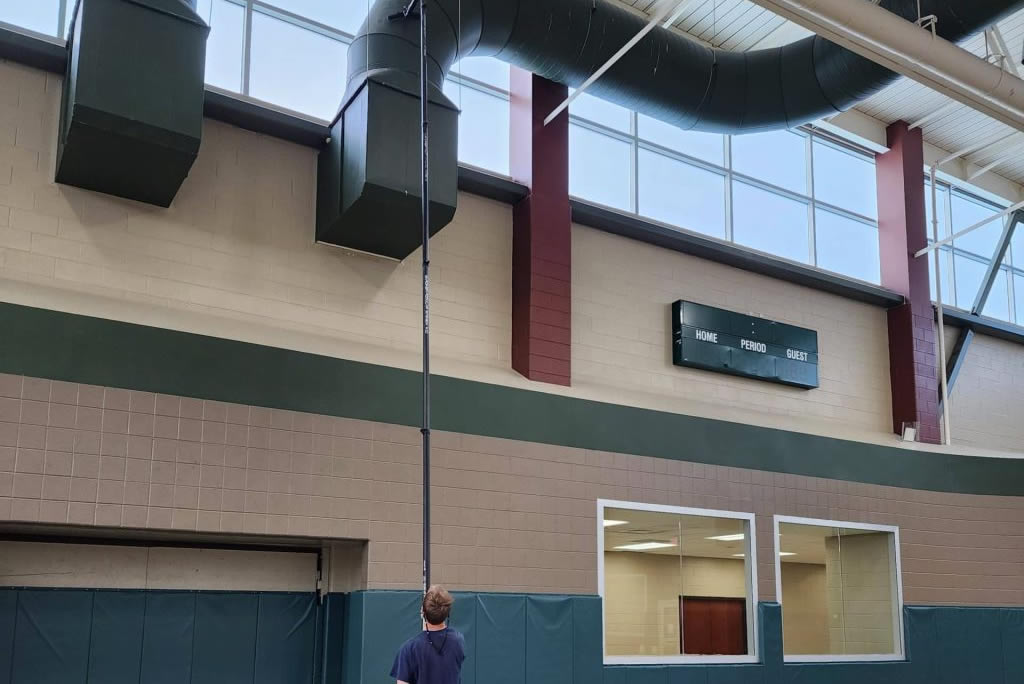 Metropolis team performing high dusting services for a gym in Loveland, CO